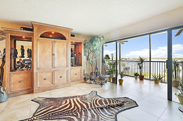 interior space with a textured ceiling and light tile floors