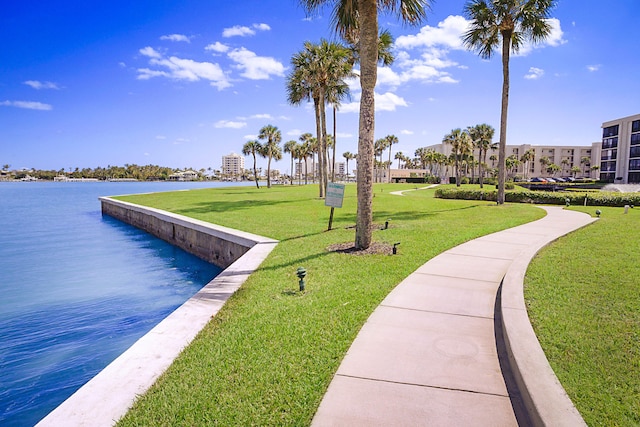 view of dock with a water view and a yard