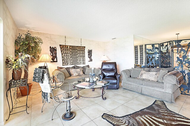 living room featuring a textured ceiling and light tile floors