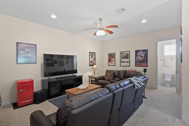 carpeted living room with ceiling fan