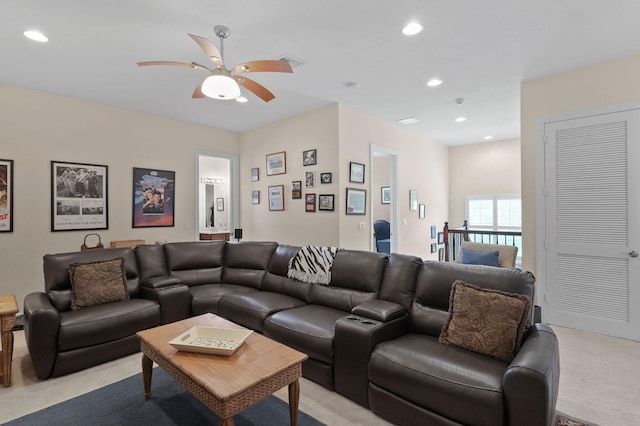 living room featuring ceiling fan and light colored carpet