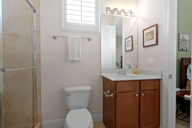 bathroom featuring a shower with shower door, oversized vanity, and toilet