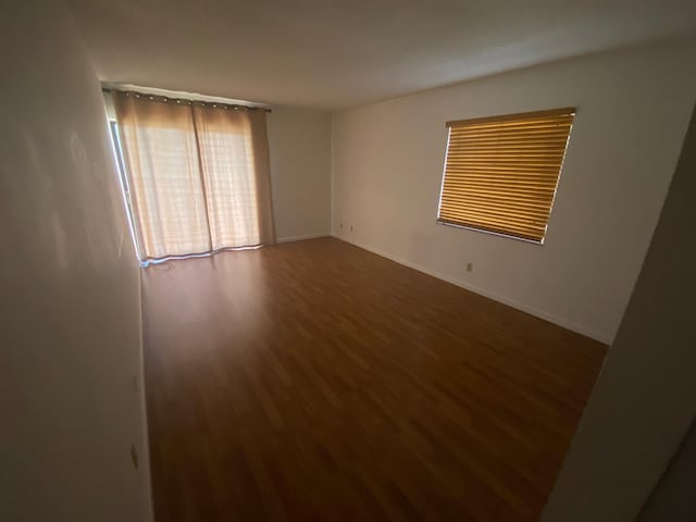 empty room with dark wood-type flooring