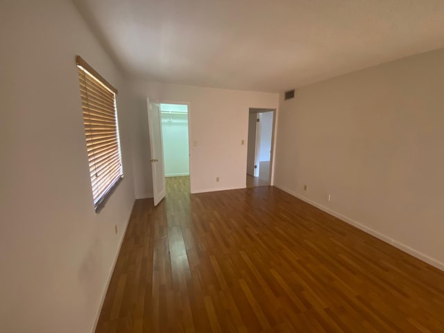 empty room with dark hardwood / wood-style floors