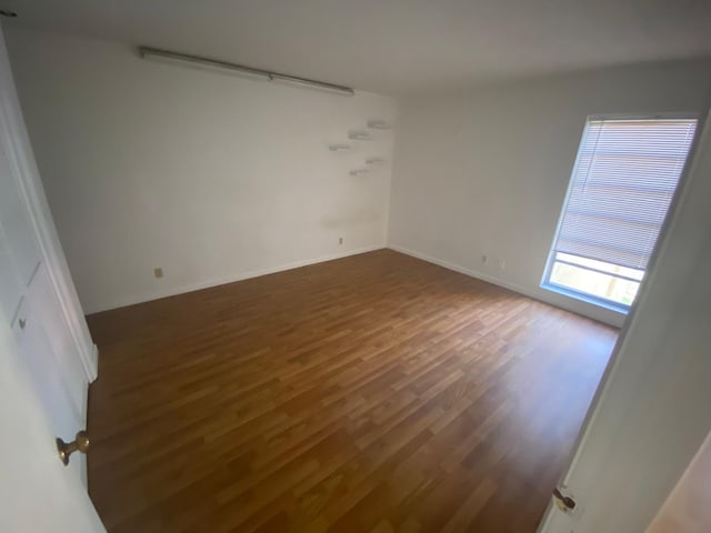 empty room with dark hardwood / wood-style floors