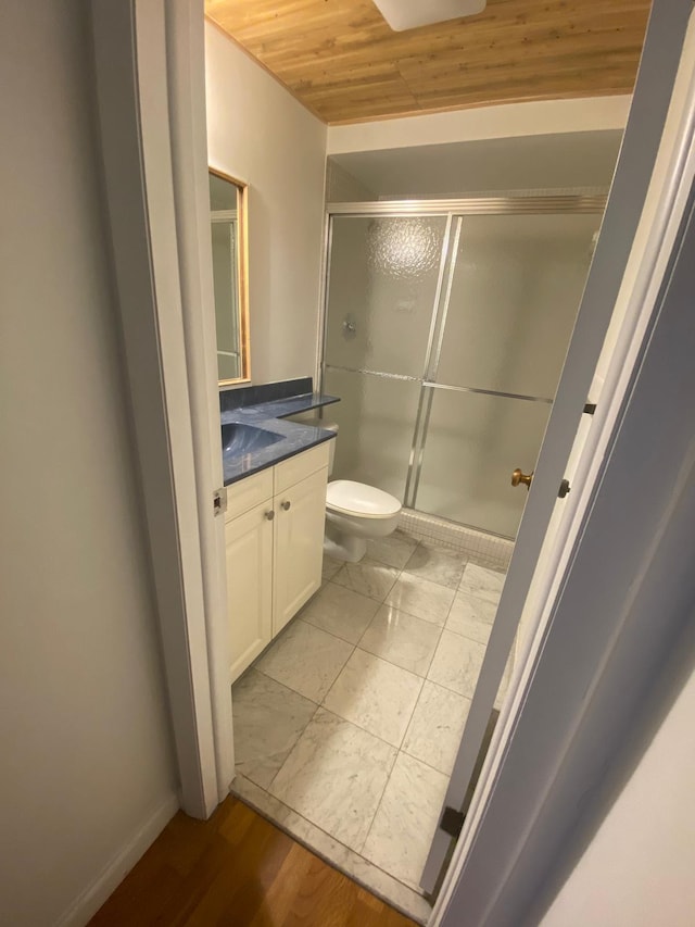 bathroom with toilet, an enclosed shower, vanity, wood-type flooring, and wooden ceiling