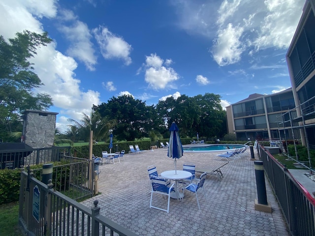 view of community featuring a patio and a swimming pool