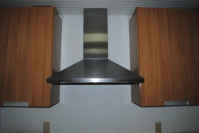 room details with wall chimney range hood