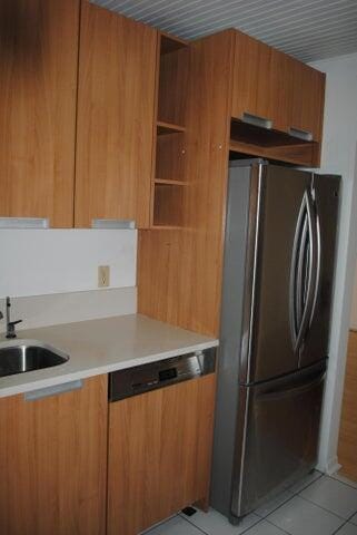 kitchen with sink, stainless steel appliances, and light tile patterned flooring