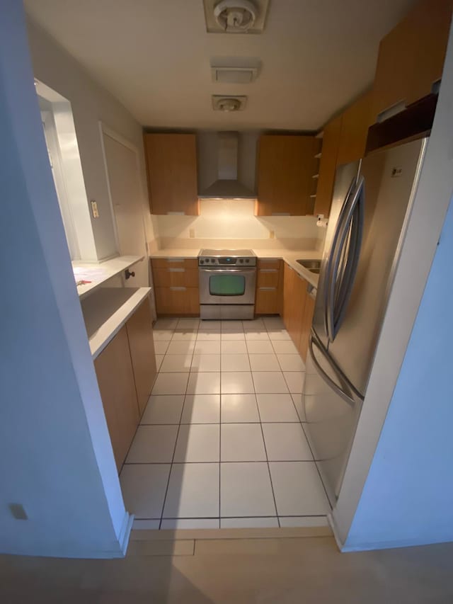 kitchen with custom range hood, stainless steel appliances, and light tile patterned flooring