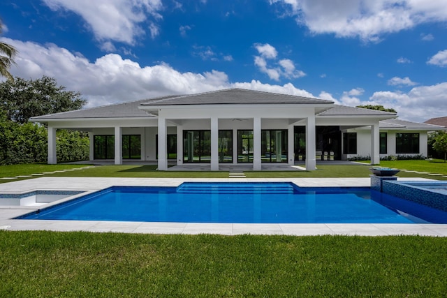 view of swimming pool with an in ground hot tub, a yard, and a patio