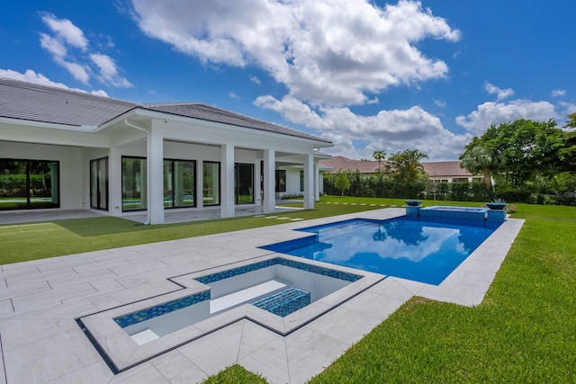 view of pool with a yard, an in ground hot tub, and a patio