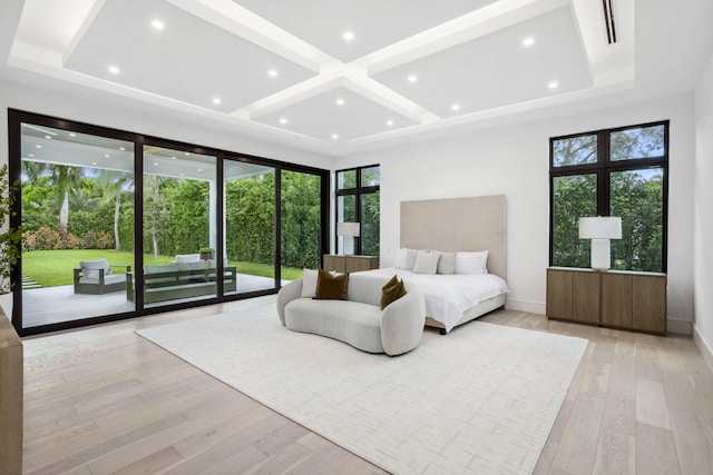 bedroom with access to outside, multiple windows, light hardwood / wood-style floors, and coffered ceiling