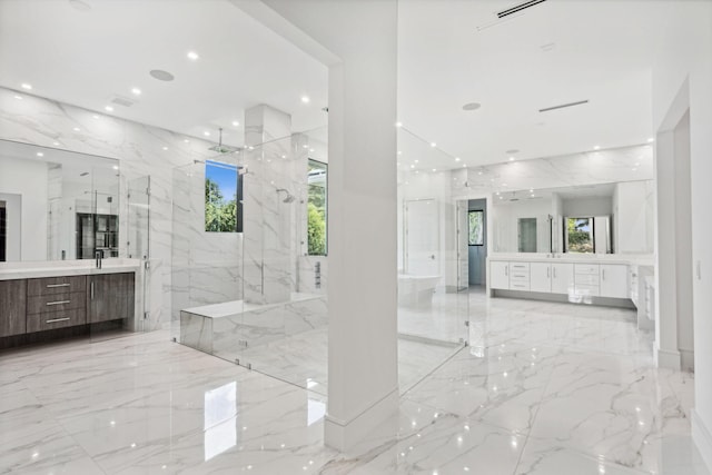 bathroom with vanity and a shower with door