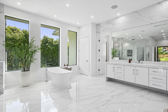 bathroom with vanity, separate shower and tub, and plenty of natural light