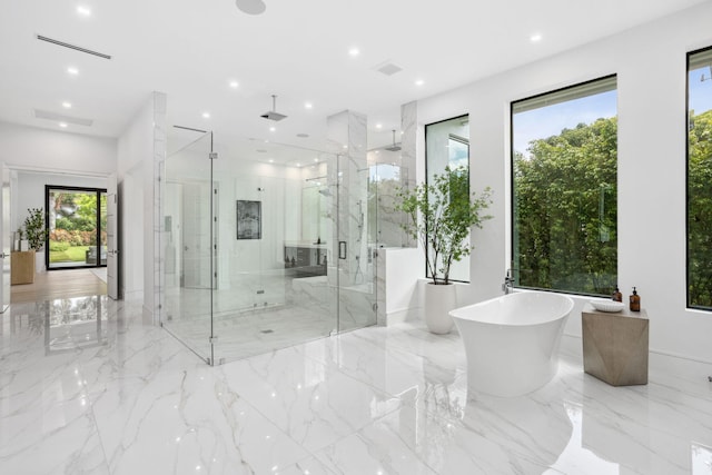 bathroom featuring separate shower and tub and a wealth of natural light