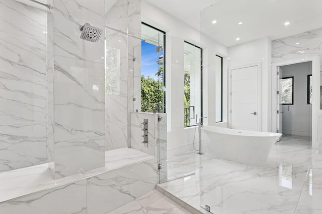 bathroom with separate shower and tub and a wealth of natural light