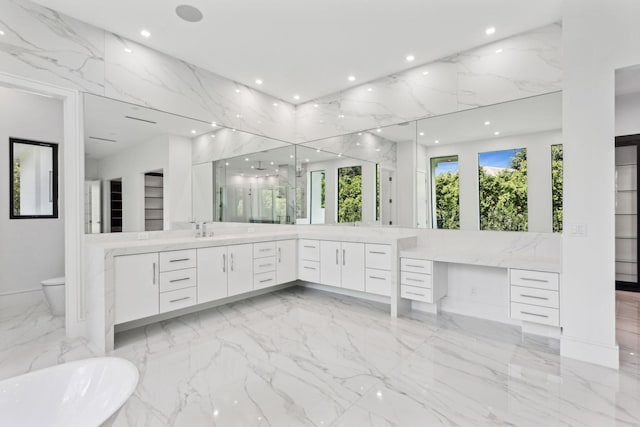 bathroom with vanity and a tub