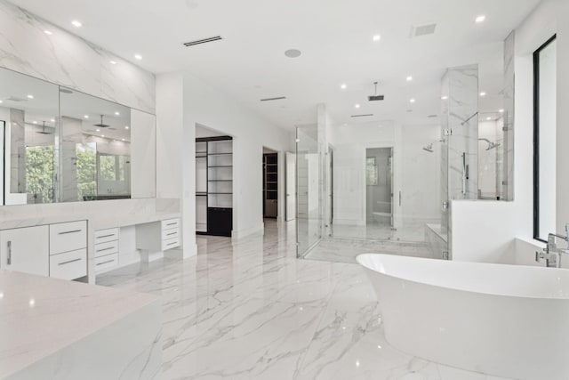 bathroom featuring vanity and separate shower and tub