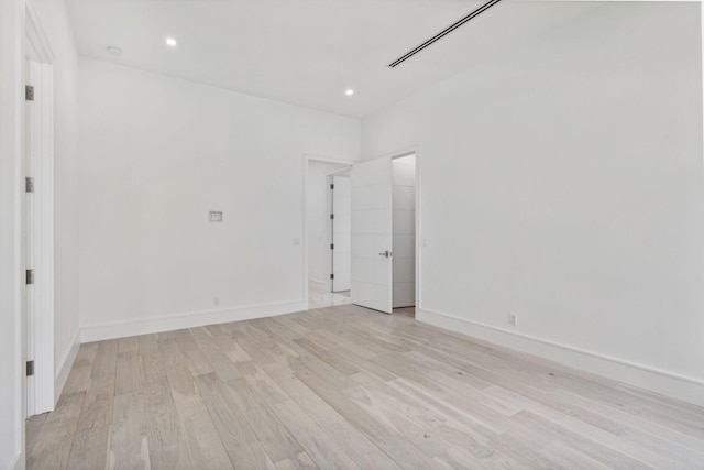 unfurnished room with light wood-type flooring