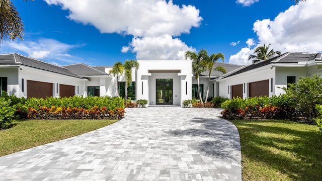 view of front of home featuring a garage and a front lawn