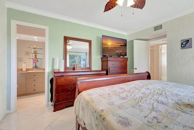 bedroom with connected bathroom, ceiling fan, a textured ceiling, light tile patterned floors, and ornamental molding