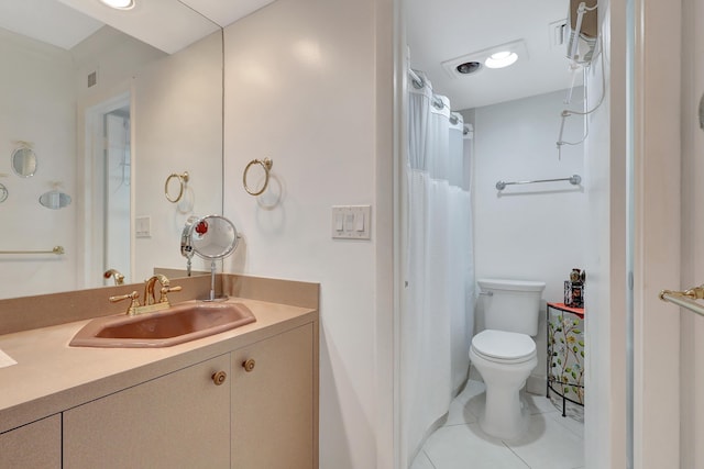 bathroom with tile patterned flooring, vanity, and toilet