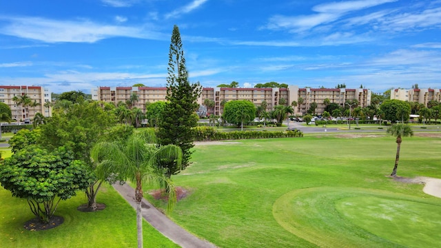 view of property's community with a lawn