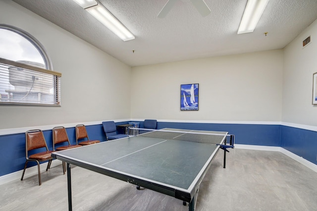 game room featuring a textured ceiling