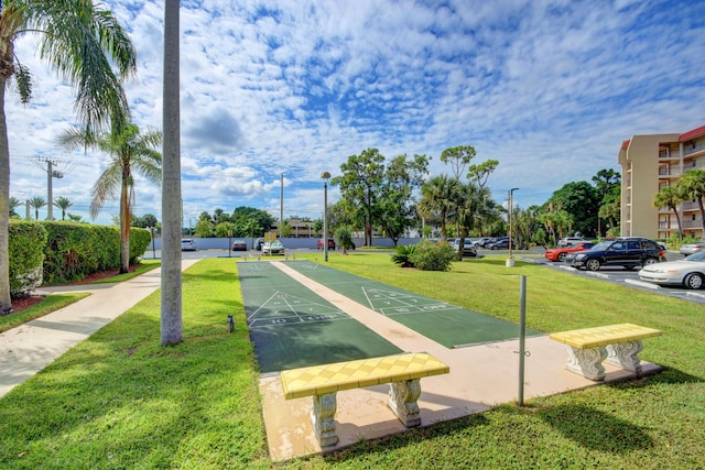 view of property's community featuring a yard