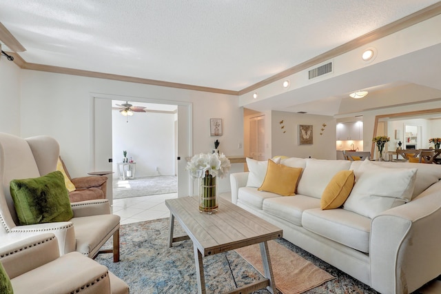 tiled living room with ceiling fan, crown molding, and a textured ceiling