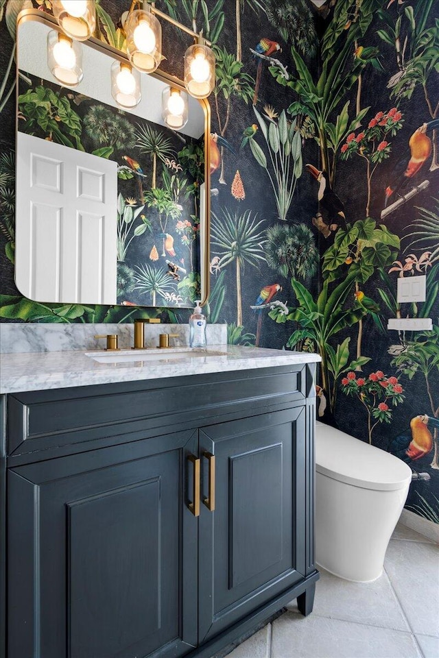 bathroom with vanity, tile patterned flooring, and toilet