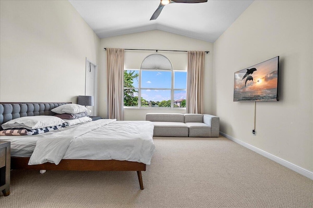 carpeted bedroom with ceiling fan and vaulted ceiling