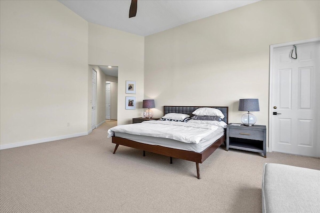 carpeted bedroom featuring ceiling fan and high vaulted ceiling