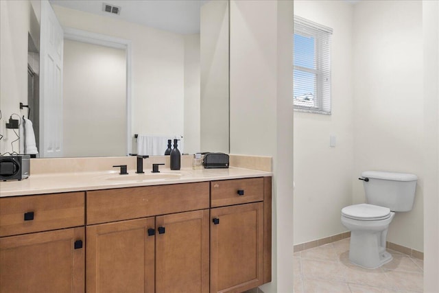 bathroom featuring tile patterned floors, vanity, and toilet