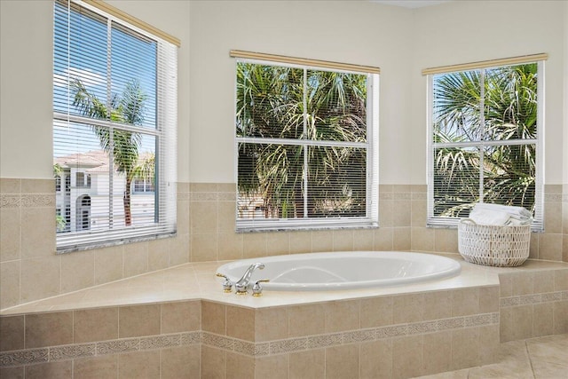 bathroom with tiled bath and tile patterned floors