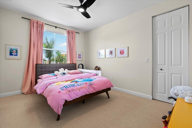 carpeted bedroom with a closet and ceiling fan