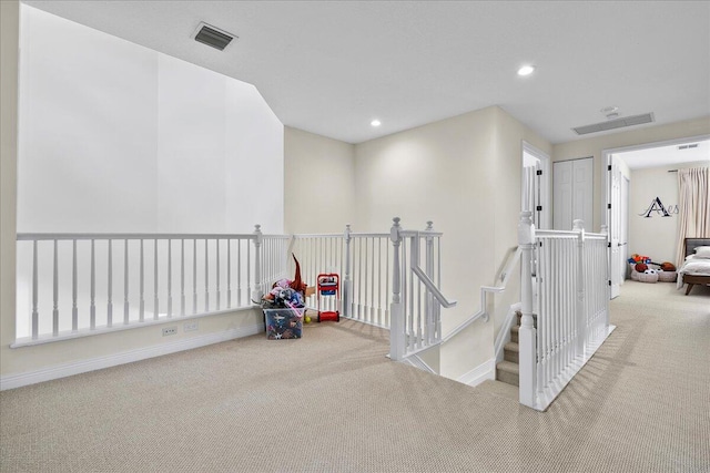 corridor with light colored carpet