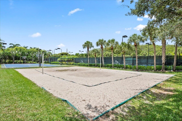 surrounding community featuring a lawn and volleyball court