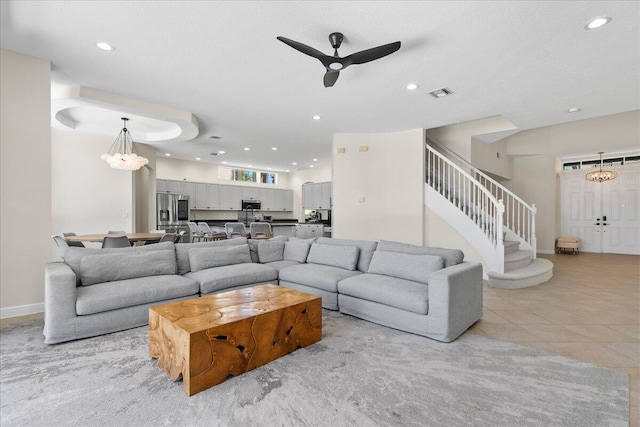 living room with ceiling fan and light colored carpet