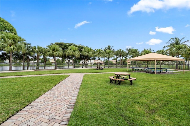 view of community with a water view, a gazebo, and a yard