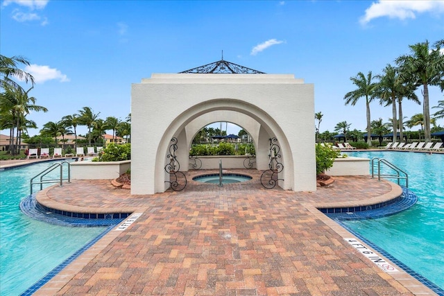 view of pool with a patio area and a community hot tub