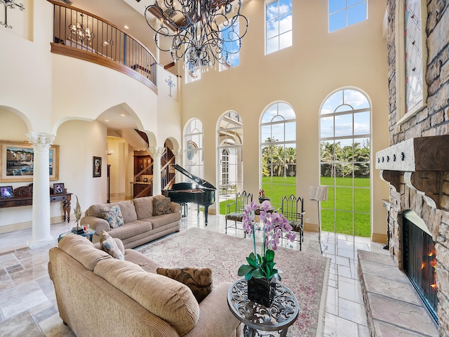 interior space with a chandelier, coffered ceiling, decorative columns, and a high ceiling