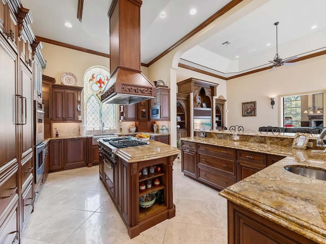 kitchen with ceiling fan, tasteful backsplash, a center island, custom range hood, and light tile patterned floors