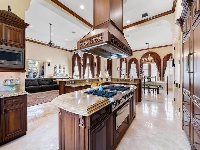 kitchen with stainless steel appliances, crown molding, decorative backsplash, a kitchen island, and custom range hood