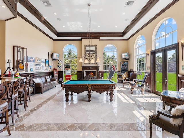 rec room featuring light tile patterned flooring, a high ceiling, billiards, crown molding, and french doors