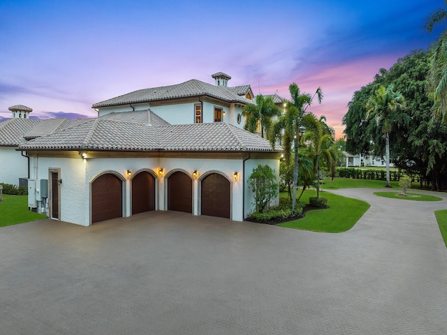 property exterior at dusk featuring a garage