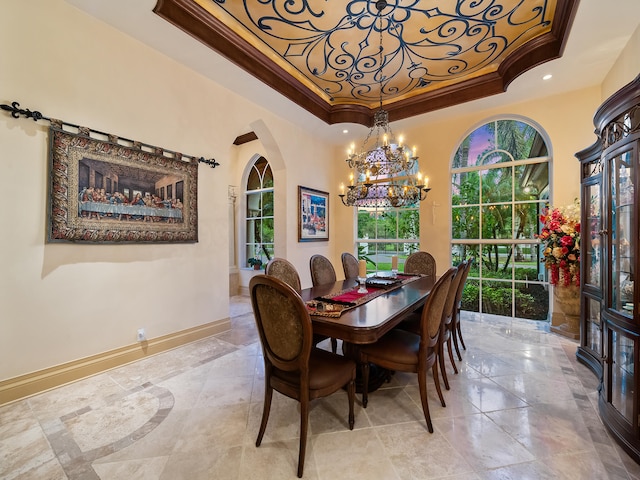 dining space with crown molding, a tray ceiling, a notable chandelier, and tile patterned floors