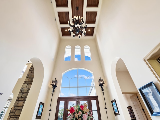 office space with crown molding, hardwood / wood-style flooring, a notable chandelier, and coffered ceiling