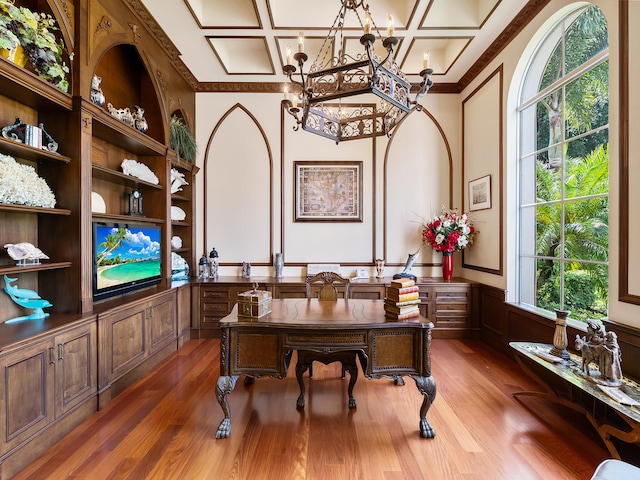 tiled foyer with a notable chandelier, decorative columns, crown molding, and a towering ceiling